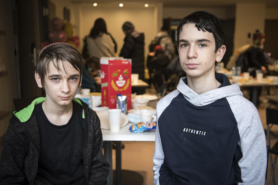 Shaul, left, and Maxim, children from an orphanage in Odesa, Ukraine, pose for a photo after their arrival at a hotel in Berlin, Friday, March 4, 2022. They spent the last 52 hours on a bus full of dozens of Jewish refugee children that took them from war-torn Ukraine in the dark of night across six European borders to safety in Berlin. (AP Photo/Steffi Loos)