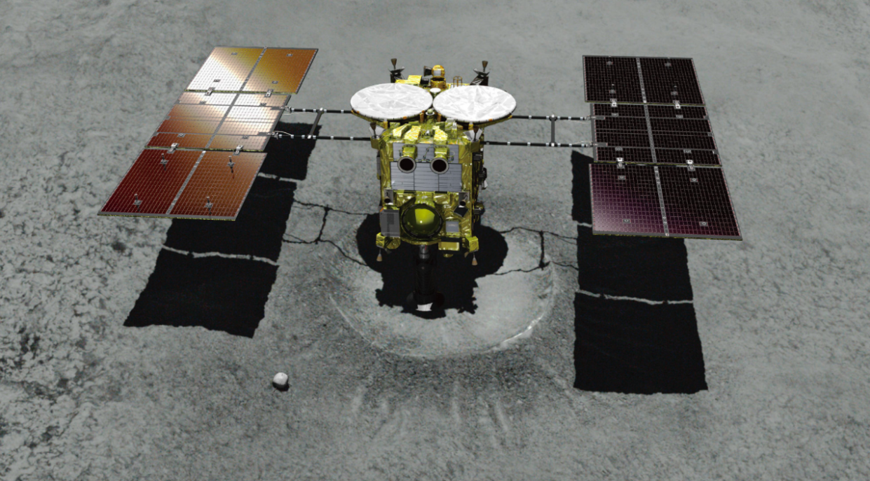 <em>This computer graphics image shows asteroid explorer Hayabusa2 landing on a crater that it made (PA)</em>