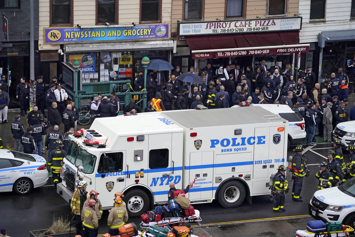 Emergency personnel gather at the entrance to a subway station in the Brooklyn borough of New York, after a gunman filled a rush-hour subway train with smoke and shot multiple people, April 12, 2022. (AP)