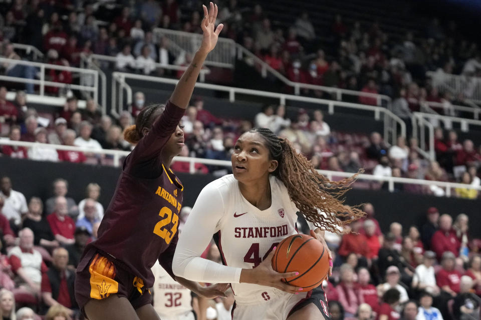 Stanford forward Kiki Iriafen, right, drives to the basket against Arizona State guard Jalyn Brown during the first half of an NCAA college basketball game in Stanford, Calif., Sunday, Feb. 25, 2024. (AP Photo/Jeff Chiu)