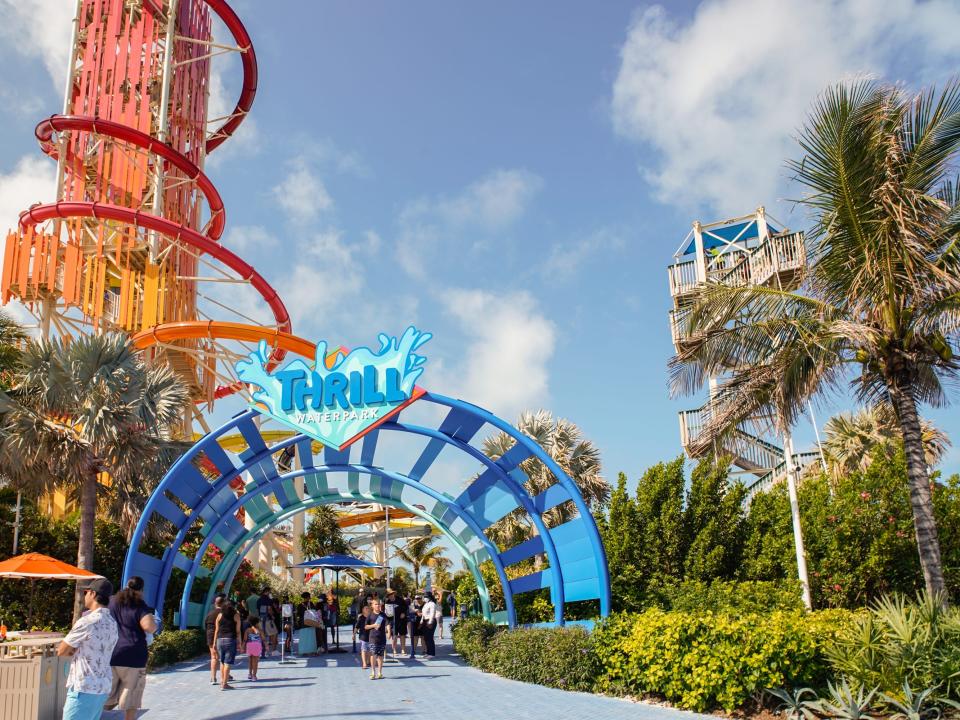 The entrance to Thrill Waterpark at CocoCay on a partly cloudy day with blue skies