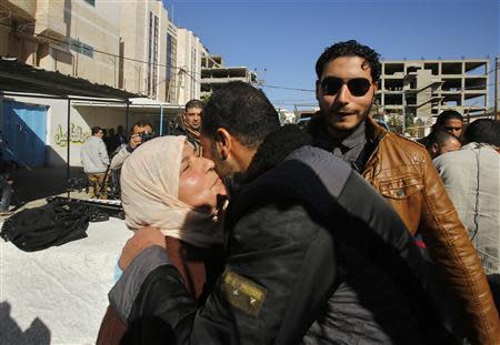 A Palestinian woman hugs her son upon his release from a Hamas-run jail in Gaza City January 8, 2014. REUTERS/Suhaib Salem