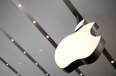 The Apple logo is pictured inside the newly opened Omotesando Apple store at a shopping district in Tokyo June 26, 2014. Picture taken June 26. REUTERS/Yuya Shino