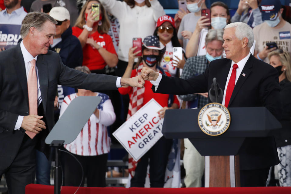 Vice President Mike Pence (right) lends his support at a rally with Sen. David Perdue (R-GA) on December 04, 2020 in Savannah, Georgia. (Photo by Spencer Platt/Getty Images)