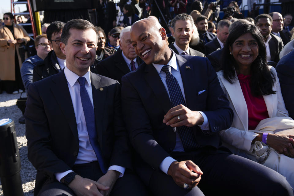 Maryland Gov. Wes Moore talks with Transportation Secretary Pete Buttigieg before President Joe Biden about infrastructure at the Baltimore and Potomac Tunnel North Portal in Baltimore, Monday, Jan. 30, 2023. (AP Photo/Andrew Harnik)