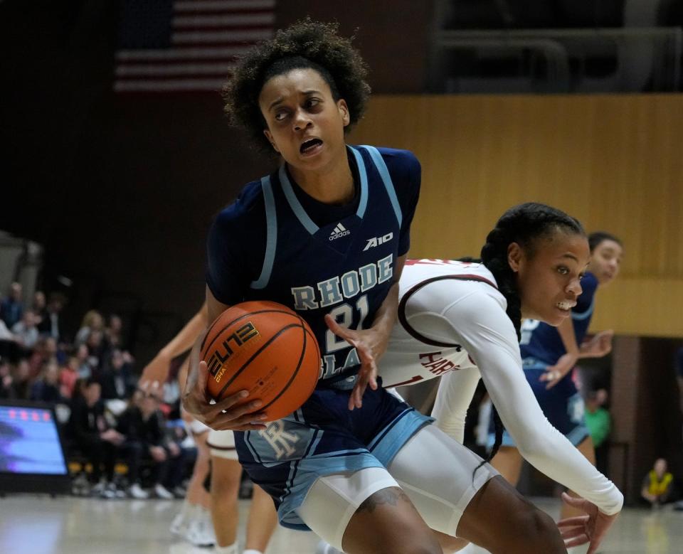 URI's Madison Hattix-Covington makes a move to the hoop against Harvard defender Harmoni Turner in the first half of Thursday's game.