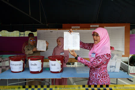 An electoral member shows a ballot during the vote counting, during the general election in Yala province, Thailand, March 24, 2019. REUTERS/Surapan Boonthanom