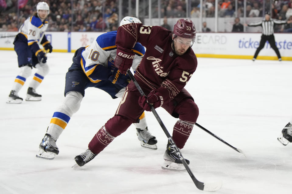 Arizona Coyotes left wing Michael Carcone skates away from St. Louis Blues center Brayden Schenn (10) in the second period during an NHL hockey game, Wednesday, Nov. 22, 2023, in Tempe, Ariz. (AP Photo/Rick Scuteri)