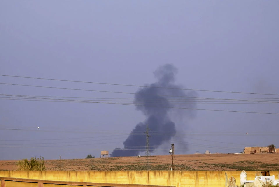 This photo by Hawar news, the news agency for the semi-autonomous Kurdish areas in Syria (ANHA), shows smoke rising from shelling by Turkish forces, at the outskirts of Ras al-Ayn, northeast Syria, Wednesday, Oct. 9, 2019. A spokesman for the U.S.-backed Kurdish-led force in northern Syria says Turkish warplanes have started targeting "civilian areas" in northern Syria. (ANHA via AP)