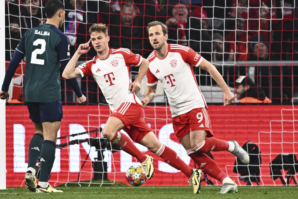 Bayern's Joshua Kimmich, center, and Harry Kane (9) celebrate after Kimmich scored during the Champions League quarter final second leg soccer match between Bayern Munich and Arsenal at the Allianz Arena in Munich, Germany, Wednesday, April 17, 2024. (Tom Weller/dpa via AP)