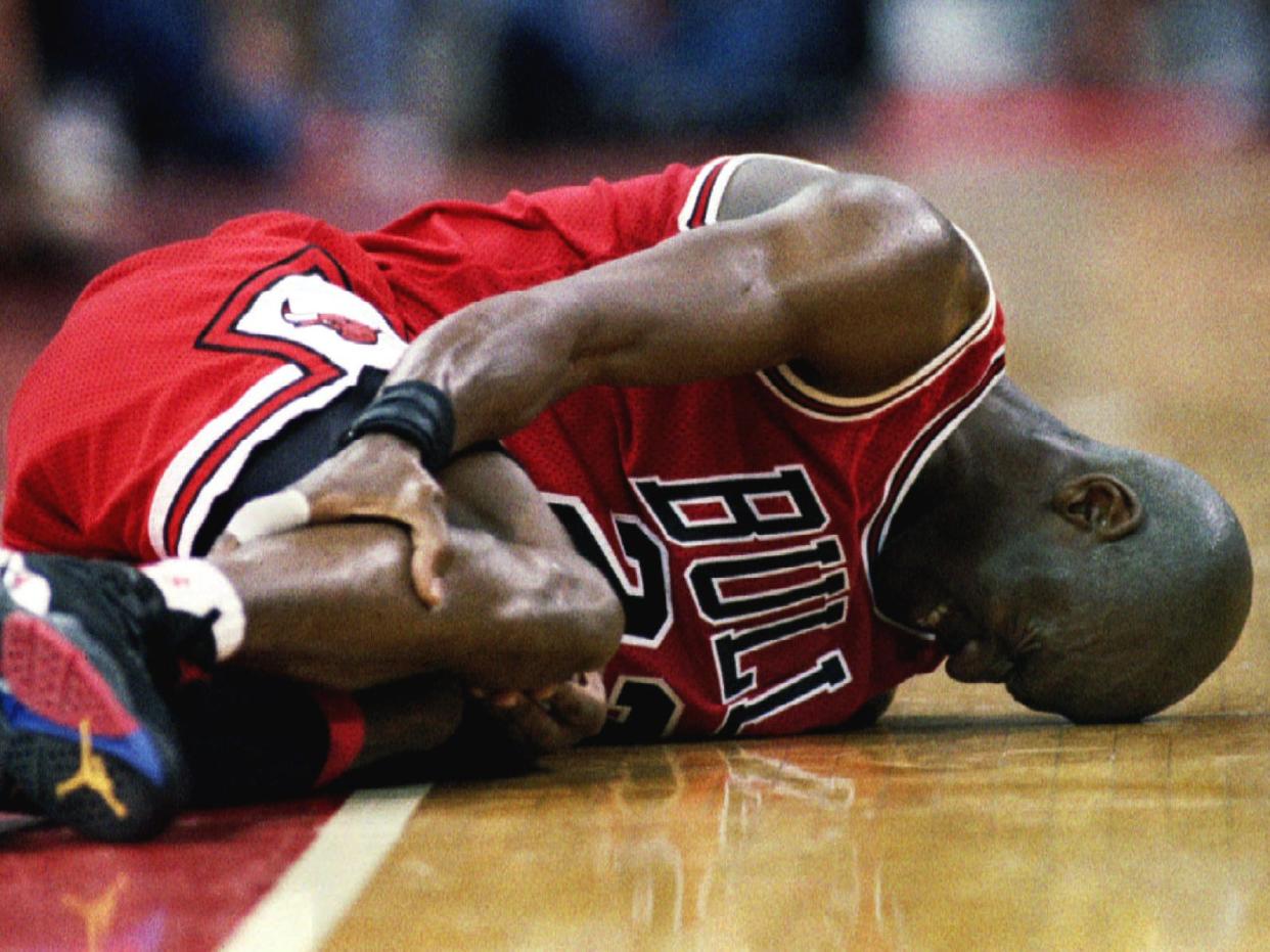 Michael Jordan clutching his leg