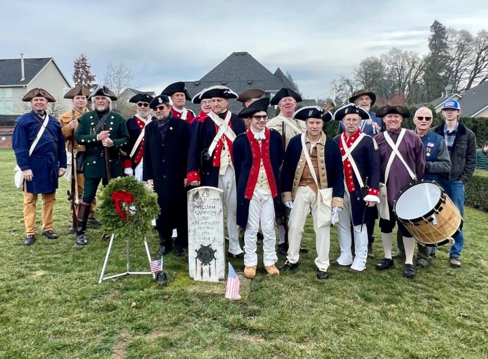 Members of the Sons of the American Revolution place a wreath at William Cannon's gravesite on Sunday at St. Paul Pioneer Cemetery in St. Paul.