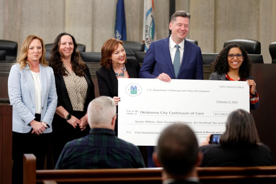 From left, Erin Goodin, executive director at City Rescue Mission; Angela Wernke, with Hope Community Services; Aubrey McDermid, assistant city manager, with Oklahoma City, Mayor David Holt; and HUD Regional Administrator Candace Valenzuela hold a check from HUD to Oklahoma City for $7.1 million during a news conference Thursday in Oklahoma City. The grant will help provide permanent housing for people experiencing homelessness.
