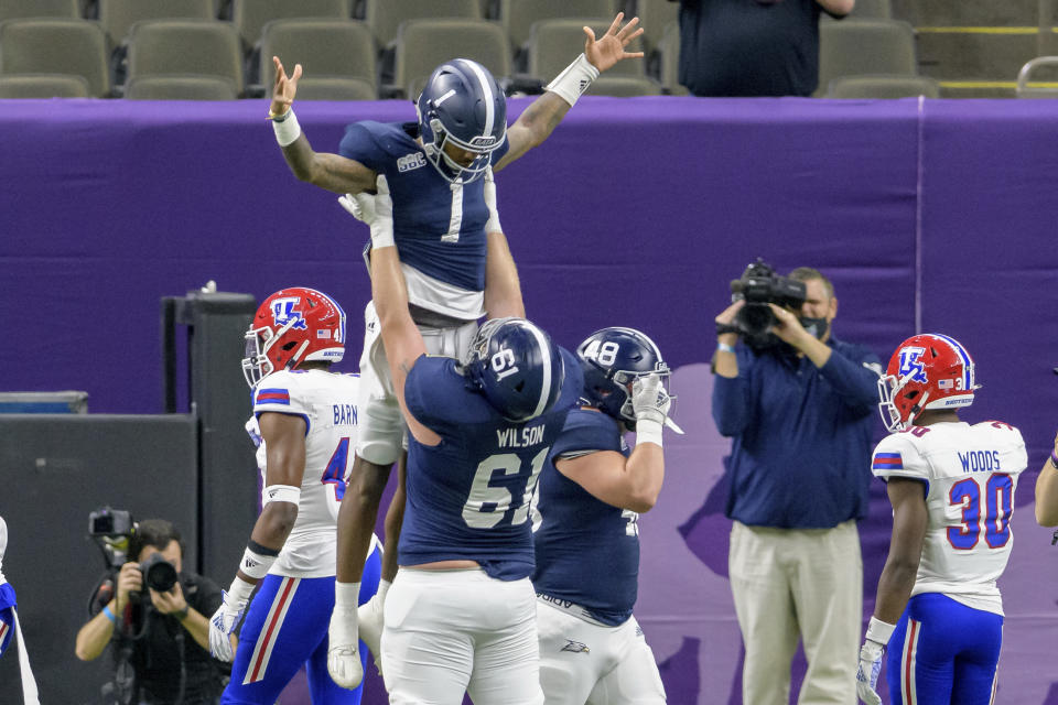 Georgia Southern quarterback Shai Werts (1) is lifted up after scoring a touchdown against Louisiana Tech during the first half of the New Orleans Bowl NCAA college football game in New Orleans, Wednesday, Dec. 23, 2020. (AP Photo/Matthew Hinton)