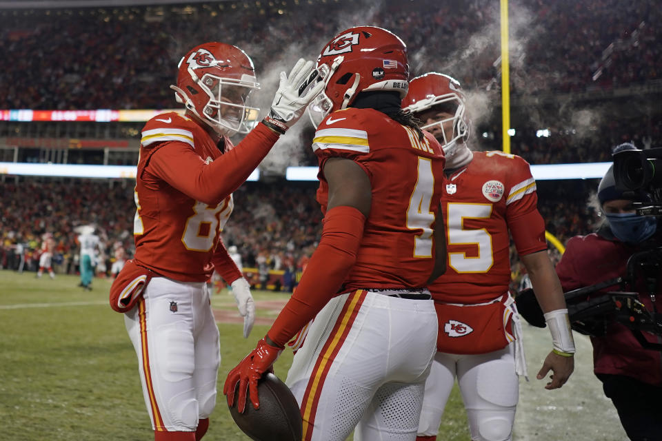 Kansas City Chiefs wide receiver Rashee Rice (4) is congratulated by wide receiver Justin Watson, left, and quarterback Patrick Mahomes after scoring against the Miami Dolphins during the first half of an NFL wild-card playoff football game Saturday, Jan. 13, 2024, in Kansas City, Mo. (AP Photo/Charlie Riedel)