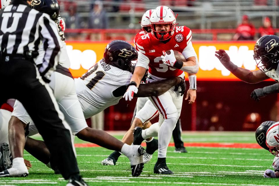 Oct 28, 2023; Lincoln, Nebraska, USA; Nebraska Cornhuskers running back Trevin Luben (35) runs against Purdue Boilermakers defensive lineman Cole Brevard (91) during the fourth quarter at Memorial Stadium. Mandatory Credit: Dylan Widger-USA TODAY Sports