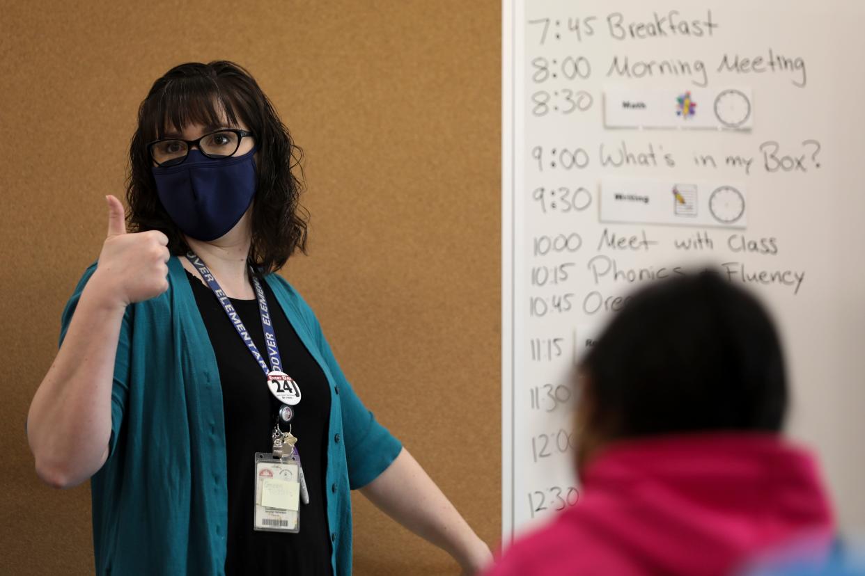 Mrs. Halverson teaches students during one of the first days back for grades two and three after closures due to the coronavirus, at Hoover Elementary School on Tuesday, March 9, 2021.