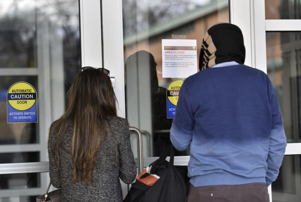 December 22, 2018 Atlanta - Visitors read an "Area Closed" sign due to a government shutdown at the Martin Luther King Jr. National Historical Park Visitor Center on Saturday, December 22, 2018. The third shutdown in less than a year could mean a tough holiday season for thousands of federal workers in Georgia and sow uncertainty for countless more who rely on government services. (Hyosub Shin/Atlanta Journal-Constitution via AP)