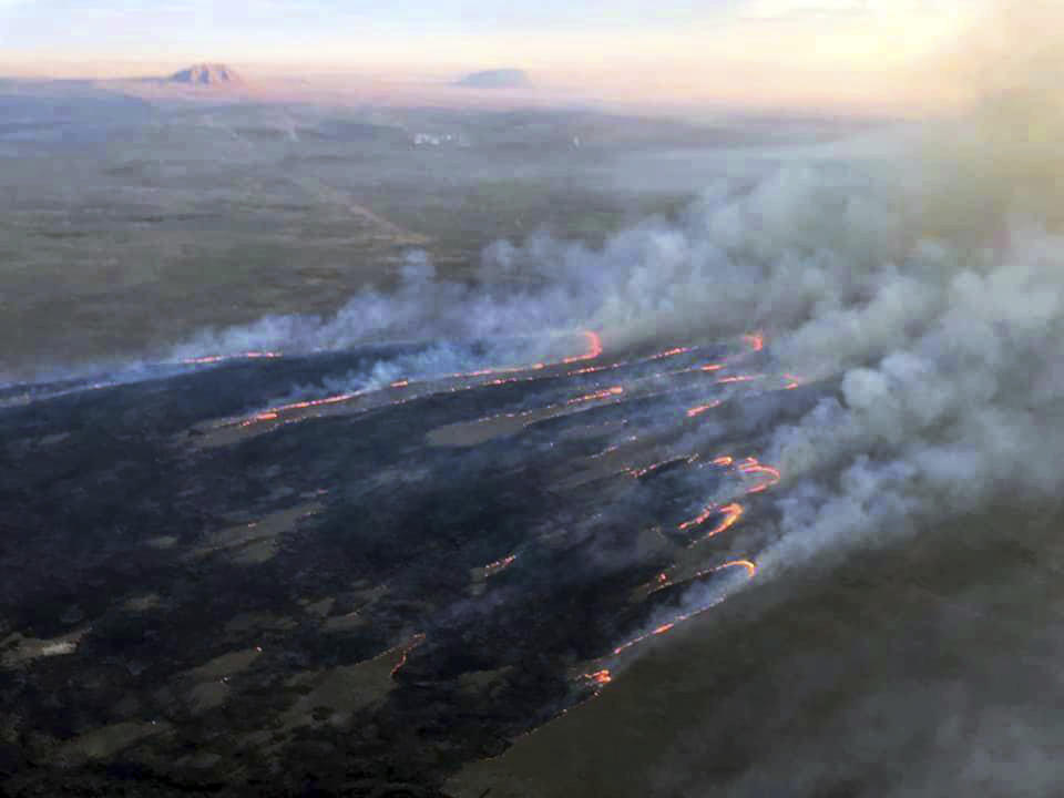 This photo provided by the U.S. Bureau of Land Management (BLM) shows wildfires burning in Idaho, Wednesday, July 24, 2019. The largest wildfire at the nation's primary nuclear research facility in recent history had been burning close to buildings containing nuclear fuel and other radioactive material, but a change in wind direction Wednesday was pushing the flames into open range at the sprawling site in Idaho, officials said. The lightning-caused fire at the Idaho National Laboratory is one of several across the U.S. West. (Bureau of Land Management via AP)