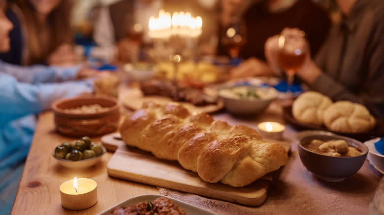 Challah and a menorah at the table