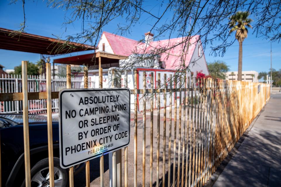 A Phoenix city code sign prohibiting camping, lying or sleeping is posted outside The Old Station near "The Zone" in Phoenix on Nov. 22, 2023.