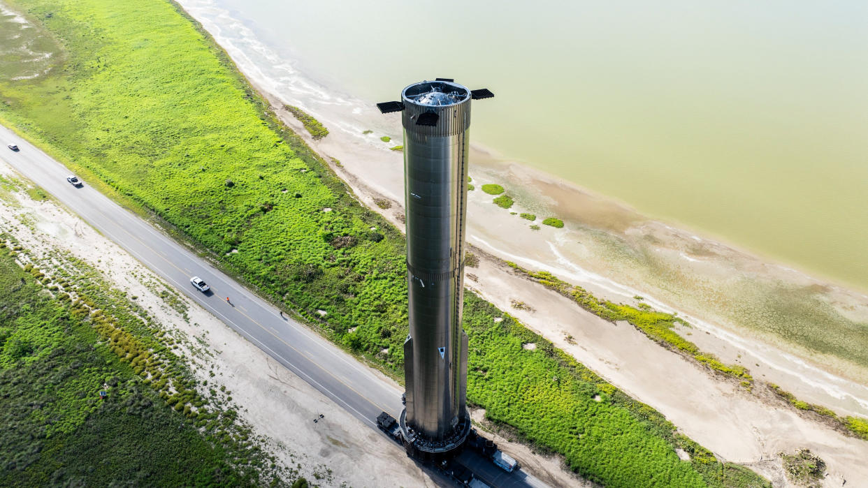  The Super Heavy booster for the fifth flight of SpaceX's Starship megarocket rolls out to the launch pad at the Starbase site in South Texas. SpaceX posted this photo on X on July 9, 2024. 