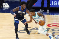 Charlotte Hornets' Malik Monk (1) drives around Minnesota Timberwolves' Jaylen Nowell (4) during the first half of an NBA basketball game Wednesday, March 3, 2021, in Minneapolis. (AP Photo/Jim Mone)