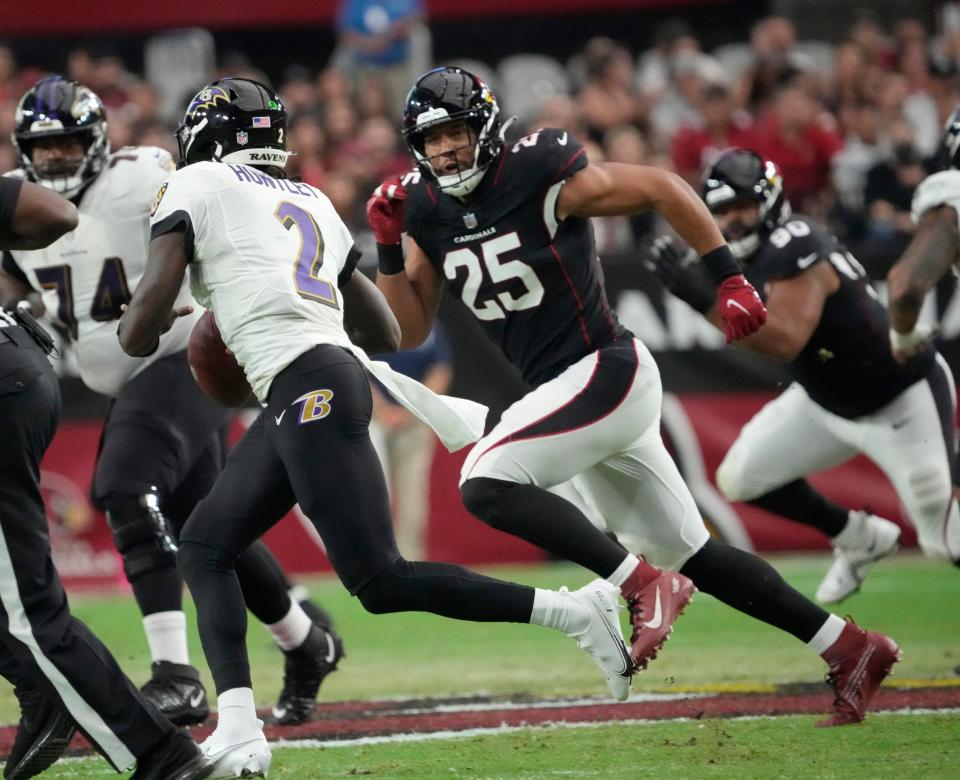 Aug 21, 2022; Glendale, Ariz., United States;  Baltimore Ravens quarterback Tyler Huntley (2) scrambles away from Arizona Cardinals linebacker Zaven Collins (25) during the first quarter in preseason action at State Farm Stadium.