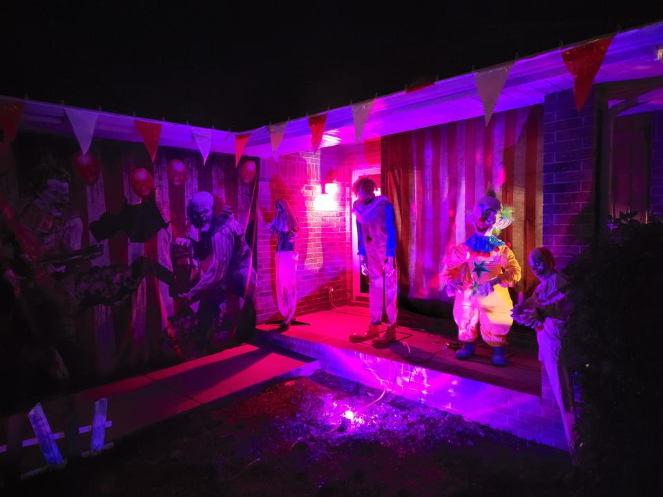 Clowns welcome guests onto the front porch of 1004 Glen Oaks Drive in Nixa. The house's front porch and lawn display an array of circus-themed Halloween decorations.
