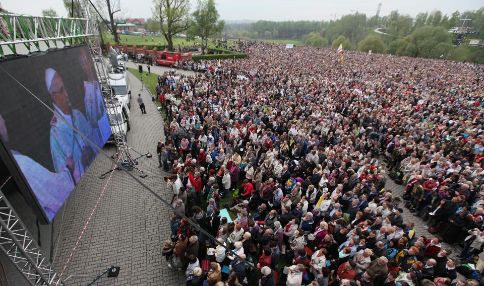 Crowds gather in God’s Mercy sanctuary in Krakow, Poland, on Sunday, April 27, 2014, for ceremonies of canonization of Polish-born Pope John Paul II. Thousands of faithful flocked to the sanctuary to watch live from the Vatican as Pope Francis, aided by emeritus Pope Benedict XVI declares John Paul and John XXIII saints, in an unprecedented ceremony involving four popes. (AP Photo/Czarek Sokolowski)