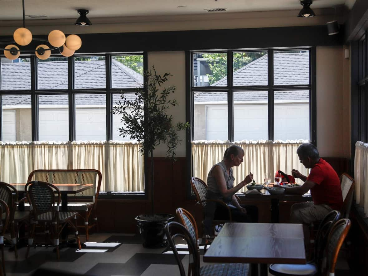 Customers enjoy a meal at Annabelle’s Kitchen in Marda Loop last June. (The Canadian Press - image credit)