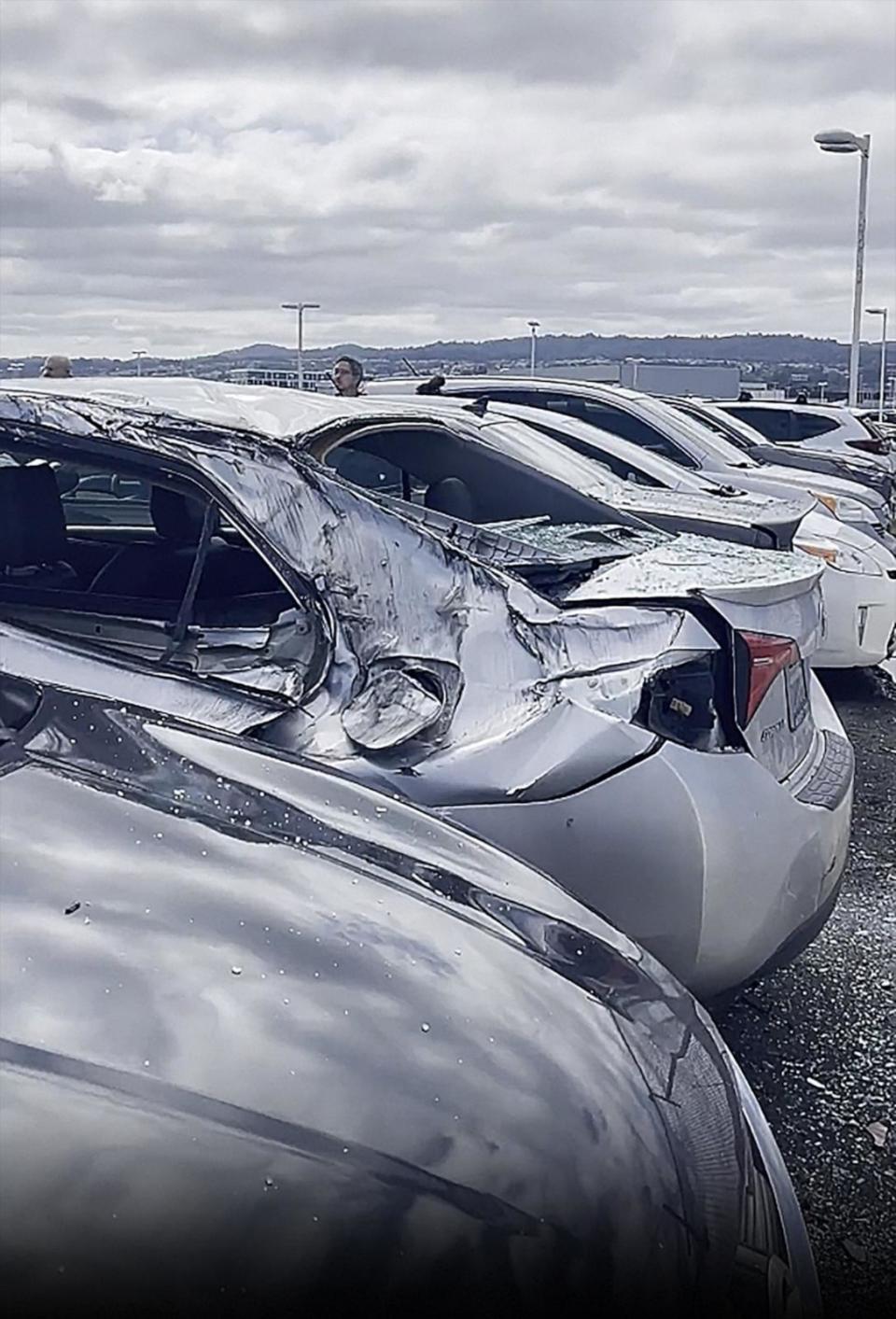 PHOTO: Damaged cars are seen in a parking lot after a United Airlines airplane lost a landing gear tire while taking off from San Francisco Airport, Mar. 7, 2024. (Buffy Bartley)