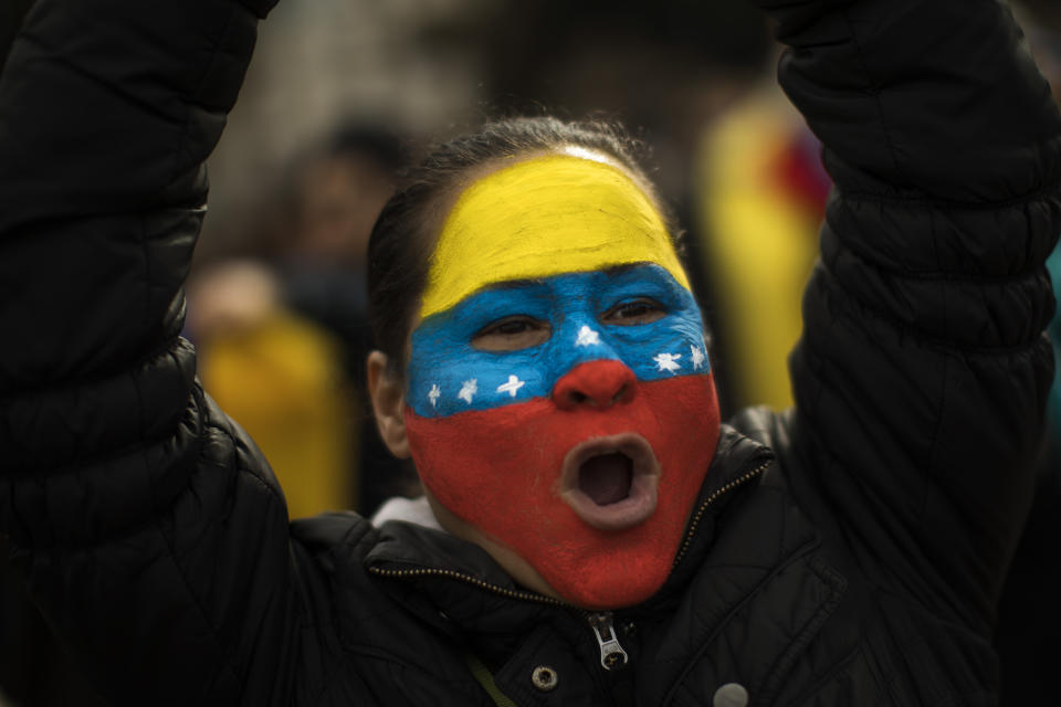 A Venezuelan woman shouts slogans as she takes part in a rally in Catalonia square, in Barcelona, Spain, Saturday, Feb. 2, 2019. Hundreds of Venezuelans gathered in downtown Barcelona, to express their support for Juan Guaido, who declared himself interim president of Venezuela last week. The gathering was one of several expected around the world to coincide with a rally planned by Guaido in Venezuela. (AP Photo/Emilio Morenatti)