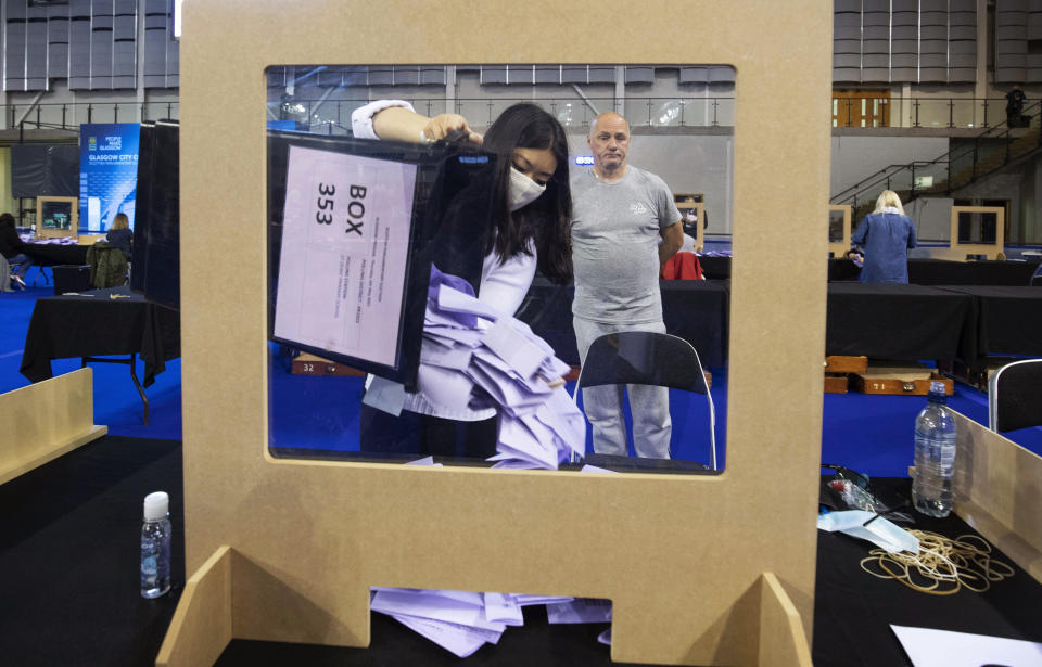 Votes are sorted to be counted for the Scottish Parliamentary Elections at the Emirates Arena,in Glasgow, Scotland, Saturday May 8, 2021. (Jane Barlow/PA via AP)