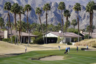 Satoshi Kodaira, center, of Japan, putts on the 17th green during the first round of The American Express golf tournament on the Nicklaus Tournament Course at PGA West, Thursday, Jan. 21, 2021, in La Quinta, Calif. (AP Photo/Marcio Jose Sanchez)