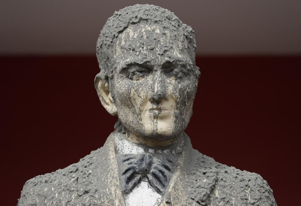 In this Wednesday, Jan. 15, 2020, photo, A statue of Philippine national hero Jose Rizal is covered in volcanic ash in Talisay, Batangas province, southern Philippines. Taal volcano is spewing lava into the sky and trembled constantly, possibly portending a bigger and more dangerous eruption, as tens of thousands of people fled villages darkened and blanketed by heavy ash. (AP Photo/Aaron Favila)