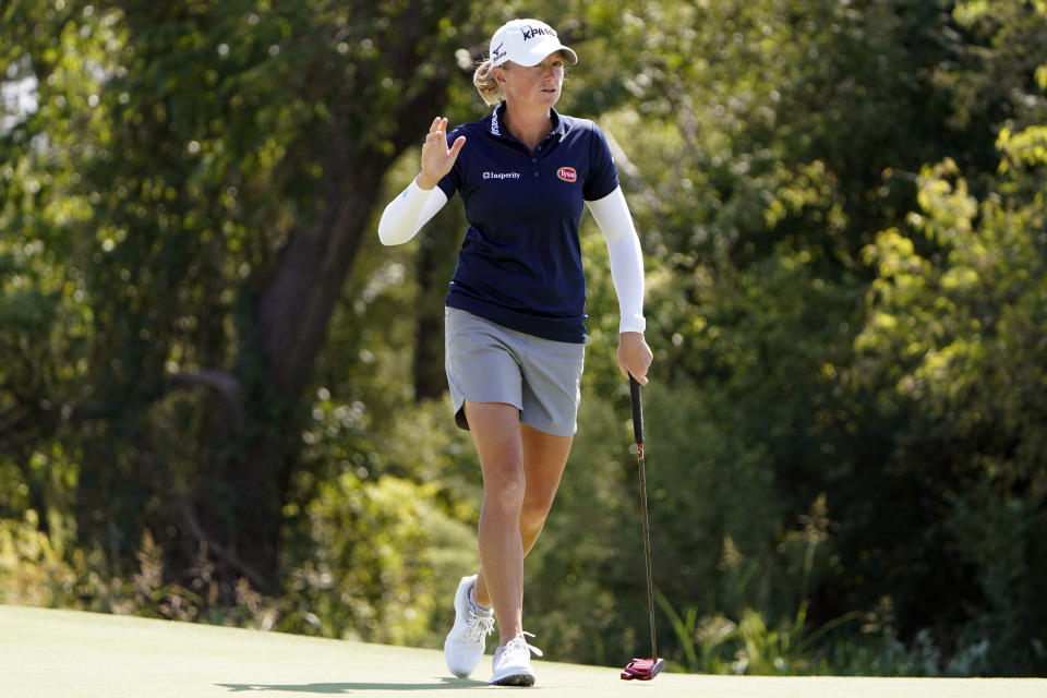 Stacy Lewis waves after sinking a putt on the eighth green during the LPGA The Ascendant golf tournament in The Colony, Texas, Thursday, Sept. 29, 2022. (AP Photo/LM Otero)