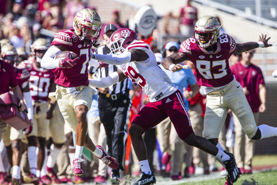 Massachusetts defensive back Cody Jones (29) shoves Florida State wide receiver Andrew Parchment (7) out of bounds in the second half of an NCAA college football game in Tallahassee, Fla., Saturday, Oct. 23, 2021. Florida State defeated UMass 59-3. (AP Photo/Mark Wallheiser)