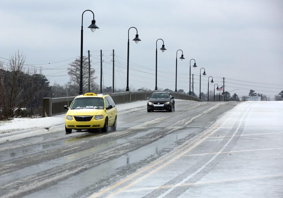 The Buddy Phillips Bridge in Jacksonville was iced over following freezing rain and snow, Jan. 22, 2022.  John Althouse / The Daily News