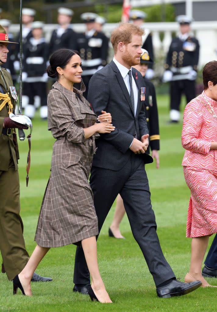 Harry and Meghan sweetly held each other as they walked around the reception.