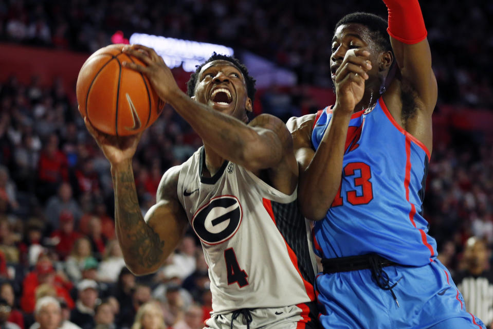 Georgia's Tyree Crump (4) looks to shoot while defended by Mississippi guard Bryce Williams (13) during an NCAA college basketball game in Athens, Ga., Saturday, Jan. 25, 2020. (Joshua L. Jones/Athens Banner-Herald via AP)