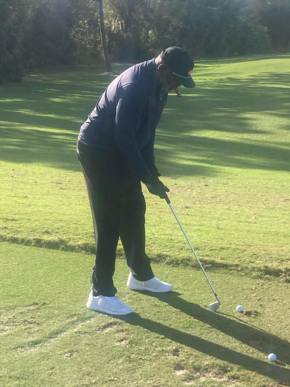 Lawrence Taylor tees off - cigar in mouth - during Monday's "Mr. October Celebrity Golf Classic" at Floridian National Golf Course in Palm City.