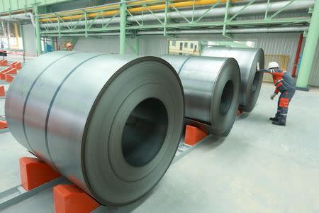 Employees examine steel products at a factory of Valin Group in Loudi, Hunan Province, China, June 15, 2014. REUTERS/Stringer