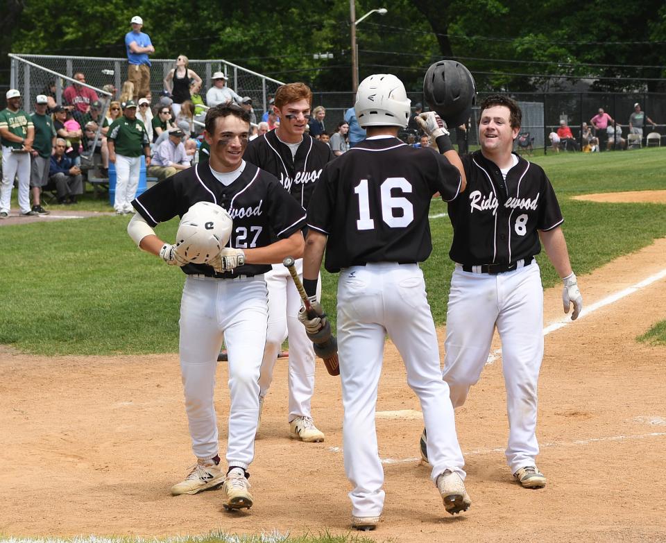 Ridgewood vs. St. Joseph in the Bergen County baseball tournament championship game on Saturday, May 25, 2019. (left) RW #27 Bret Thompson and #11 Sam Favieri after scoring on a homerun hit by (right) RW #8 Brian Skettini.