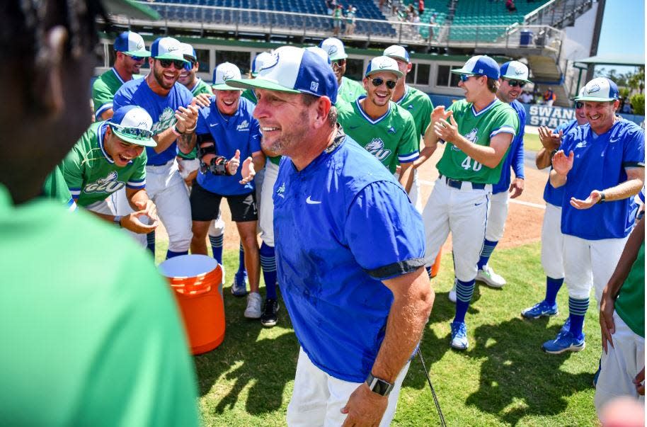 FGCU baseball coach Dave Tollett celebrates with his team after winning his 700th career game on Sunday against Jacksonville State.