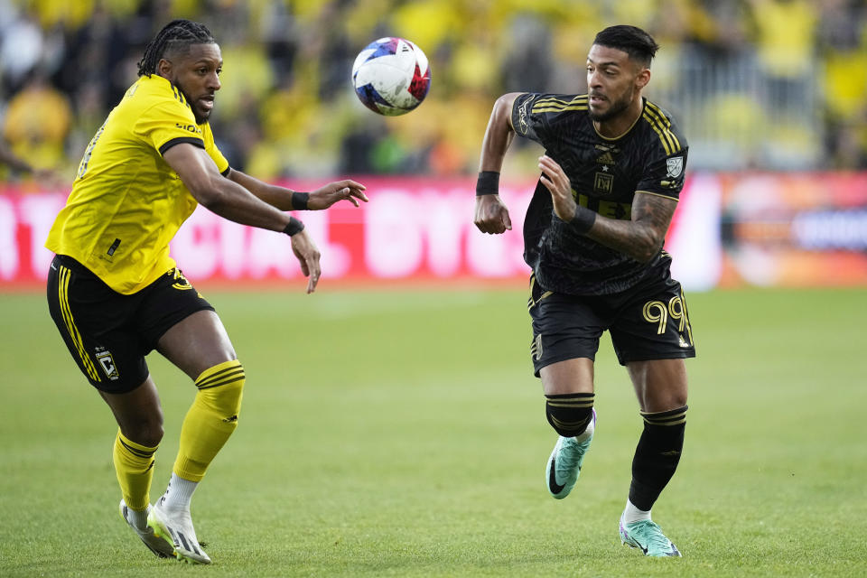 RETRANSMITTING TO CORRECT TEAM TO LOS ANGELES FC - Columbus Crew's Steven Moreira, left, and Los Angeles FC's Denis Bouanga, right chase after the ball in the first half of the MLS soccer championship match, Saturday, Dec. 9, 2023, in Columbus, Ohio. (AP Photo/Sue Ogrocki)