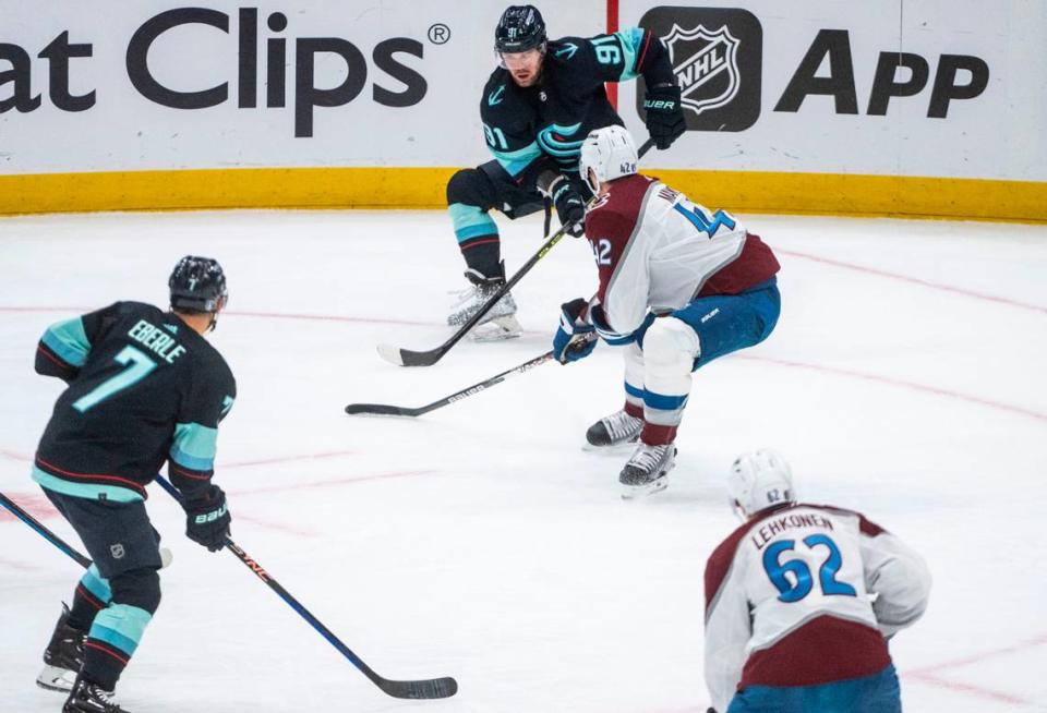 Seattle Kraken right wing Daniel Sprong (91) looks to pass the puck as Colorado Avalanche defenseman Josh Manson (42) defends during the first period of a first round 2023 Stanley Cup Playoffs game at Climate Pledge Arena in Seattle on Monday, April 24, 2023.