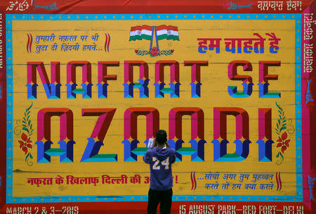 A man takes a picture of an art installation at an event titled "Artists Unite", during which various artists signed to register their concern against hate and intolerance, at a public park in New Delhi, March 2, 2019. REUTERS/Anushree Fadnavis/Files