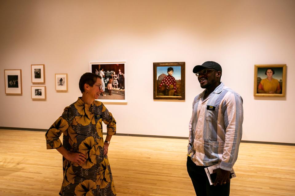 Lauren Lessing, director of the Stanley Museum of Art, left, talks with Derek Nnuro, curator of special projects, in the "Homecoming" exhibition, which comprises a series of installations, Tuesday, Aug. 23, 2022, at the Stanley Museum of Art on the University of Iowa campus in Iowa City, Iowa.