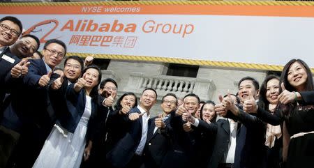 Alibaba Group Holding Ltd founder Jack Ma (2nd L) poses as he arrives at the New York Stock Exchange for his company's initial public offering (IPO) under the ticker "BABA" in New York September 19, 2014. REUTERS/Brendan McDermid